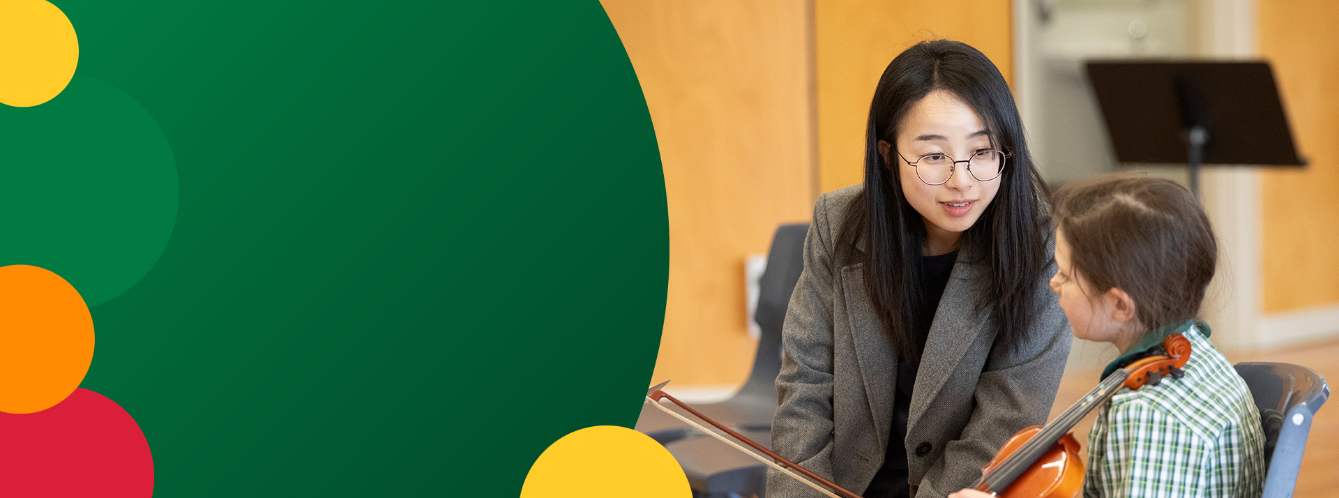 Student learning to play the violin from her teacher at St Mary MacKillop Primary School South Penrith
