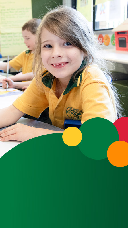 Student smiling in the classroom at St Mary MacKillop Primary School South Penrith