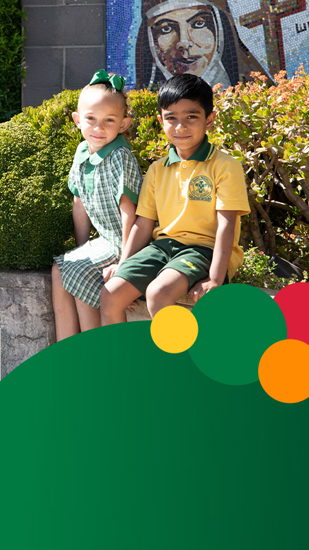 Students sitting together outside at St Mary MacKillop Primary School South Penrith