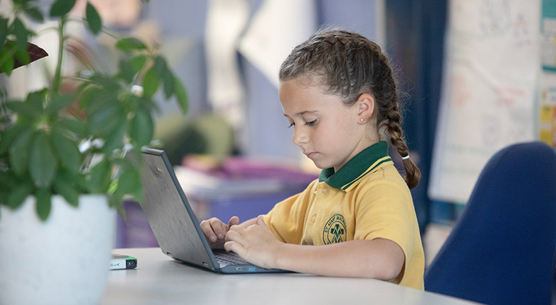 Student at her desk in the classroom at St Mary MacKillop Primary School South Penrith