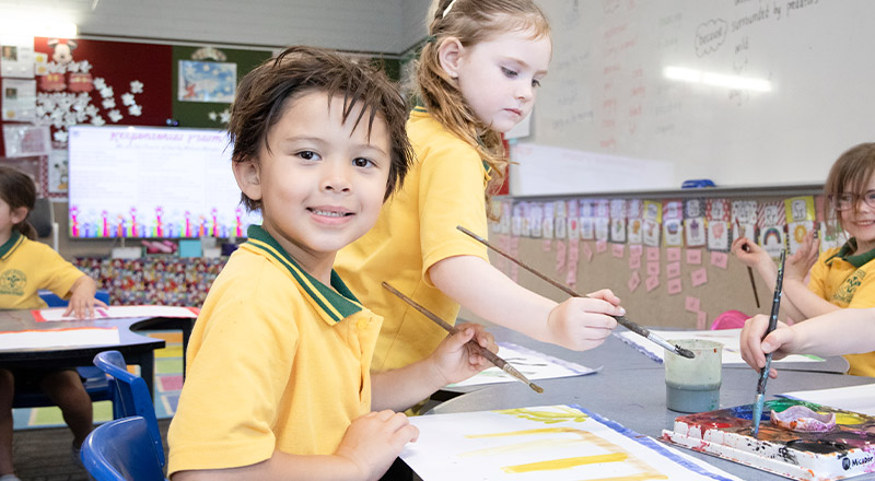 Student painting in the classroom at St Mary MacKillop Primary School South Penrith