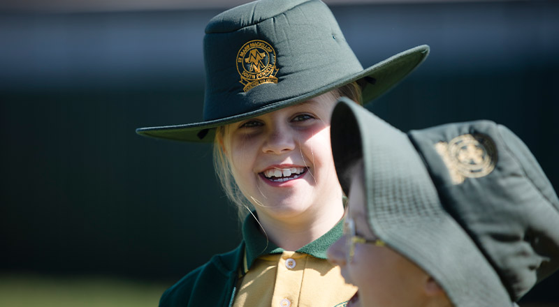 Student wearing her hat in the playground at St Mary MacKillop Primary School South Penrith