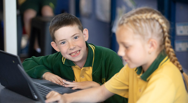 Student smiling in the classroom at St Mary MacKillop Primary School South Penrith