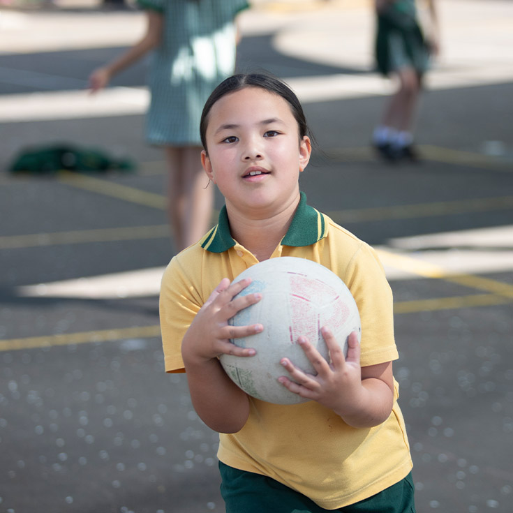 Student catching a ball in the playground at St Mary MacKillop Primary School South Penrith