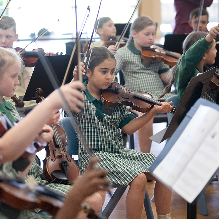 Students playing instruments in the classroom at St Mary MacKillop Primary School South Penrith