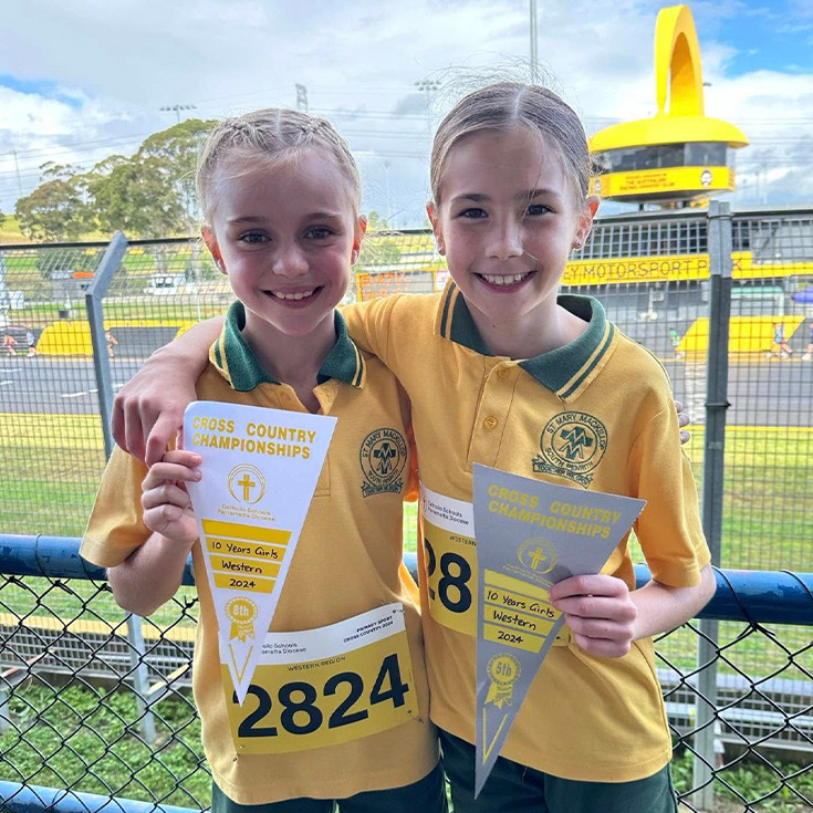 Students holding their competition ribbon after participating in the sport carnival at St Mary MacKillop Primary School South Penrith