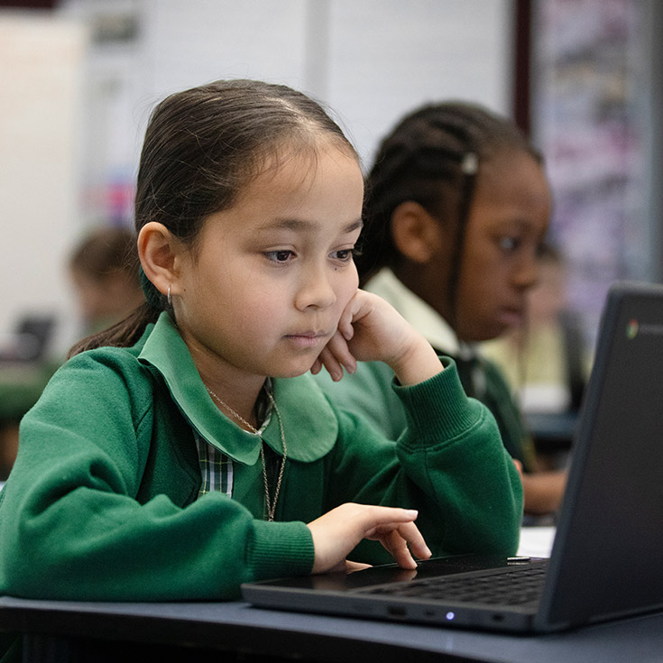 Student working on her laptop in the classroom at St Mary MacKillop Primary School South Penrith