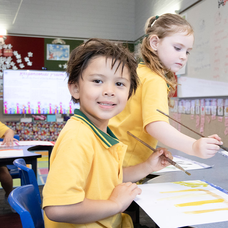 Student sitting at his desk in the classroom at St Mary MacKillop Primary School South Penrith