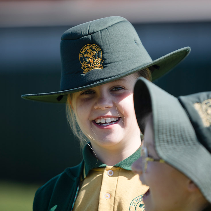 Student smiling in the playground at St Mary MacKillop Primary School South Penrith