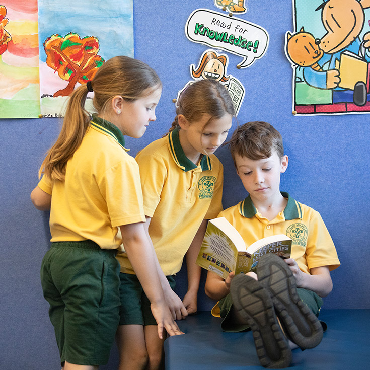 Students reading together in the library at St Mary MacKillop Primary School South Penrith