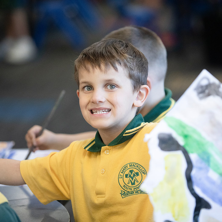 Student smiling in the classroom at St Mary MacKillop Primary School South Penrith