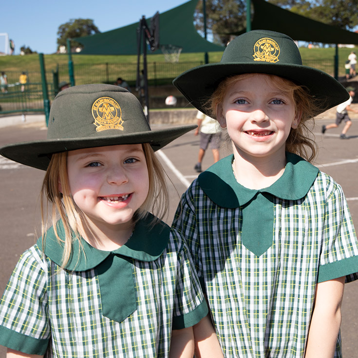 Students wearing their summer uniforms in the playground at St Mary MacKillop Primary School South Penrith